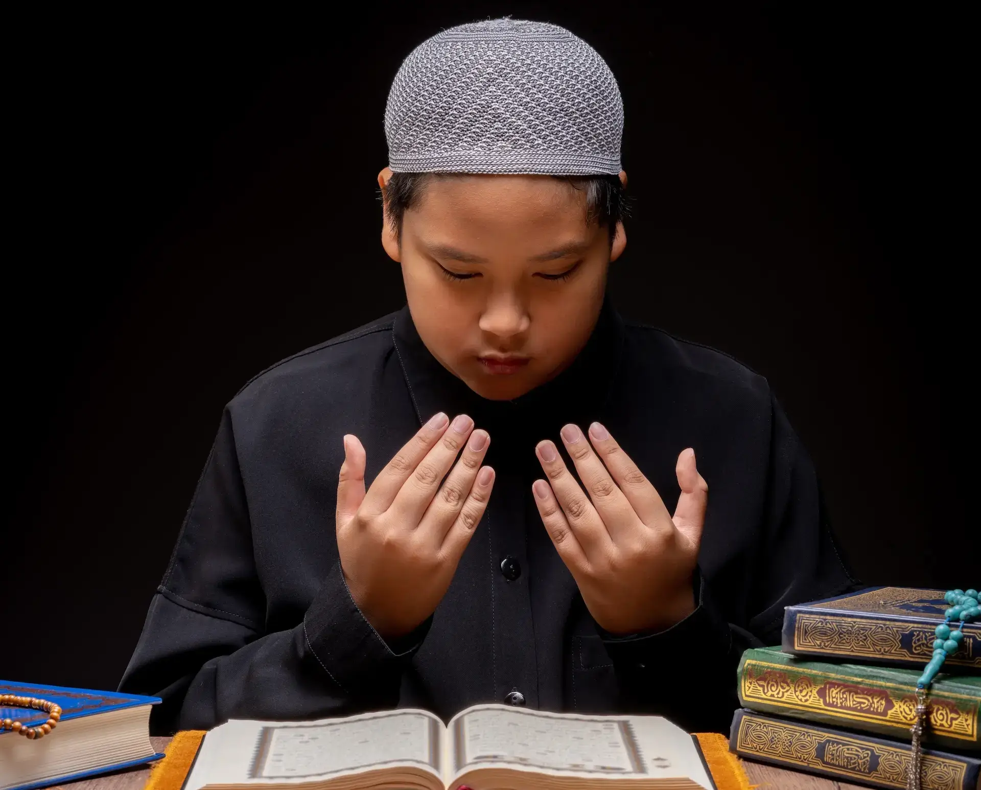Student reading Quran in a mosque
